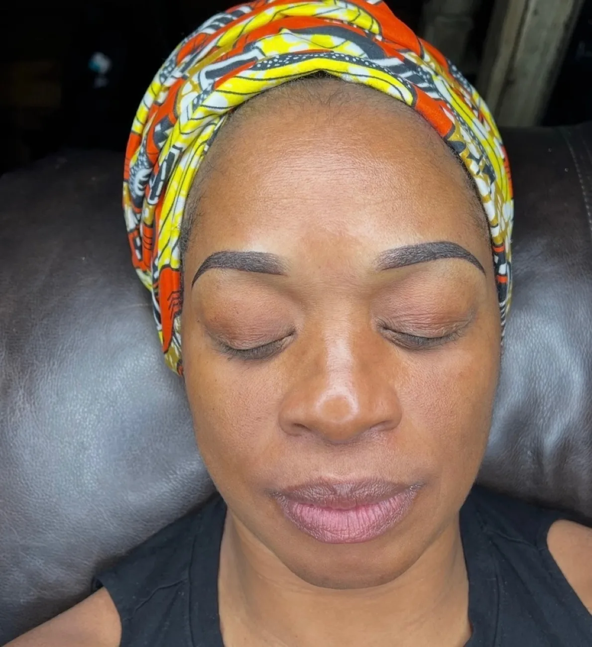Same client after ombré powder brows — balanced, fuller brows framing the face.