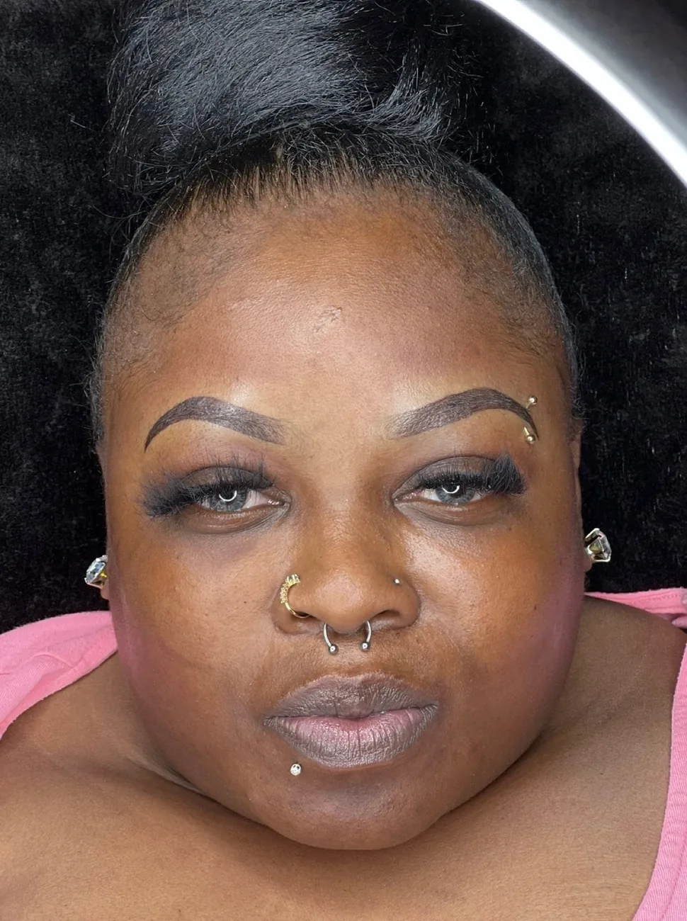 Same client after ombré powder brows — defined arch and even color across both brows.